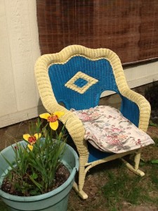 two lilies, and wicker rocking chair