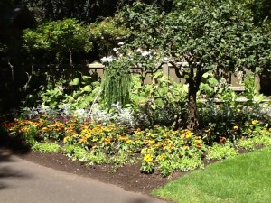 Apple tree, floral borders, mixed plantings, all give interest and movement to the garden at the Filberg in Comox, B.C.