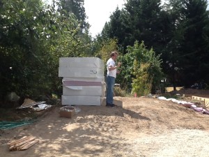 Tom, next to a stack of insulation like the pink stuff under the wire grids.