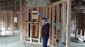 Mother, in front of the (eventual) fireplace, there is a grayish-brown fiberglass batting now filling walls around the perimeter of the house and many inside.  And the ceiling in the vaulted parts...