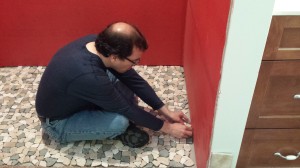 Tom placing the floor tile...  the edges were particularly time-consuming.