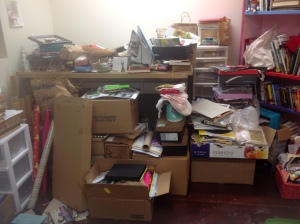 It's not pretty, but this pile of boxes holds art and sewing supplies as well as some books and papers that I want to keep.  The tall bookcase on the right has a lot of middle-school level books, which are going to be gifted soon to friends -- then the shelves will be for the many fabrics and papers I store for projects!